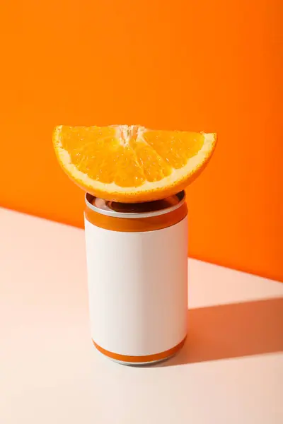 Tin cans and oranges on orange background, space for text