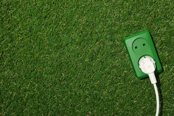 Electric socket with cable on the grass