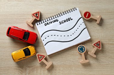 Hafif arka planda trafik işaretleri ve araçlar.