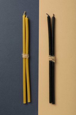 Light and dark magic candles twisted into a pile.