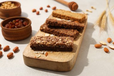 Tahta bir tahtanın üzerinde mısır ve fındık kulaklı granola çubukları.