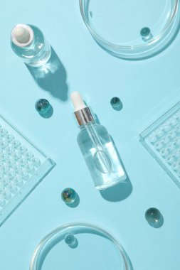 Mavi arka planda şeffaf kozmetik şişeler