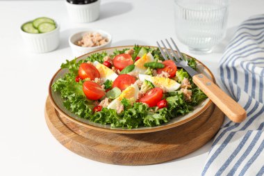 Ready salad with tuna on a wooden board. clipart