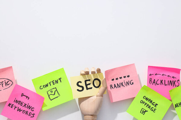 Colored papers with words on white background, top view