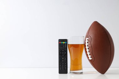 Beer with a rugby ball on a light background clipart