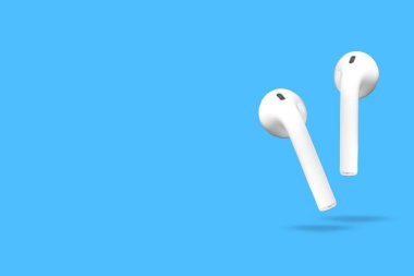 Yüzen kablosuz kulaklıklar canlı bir mavi arkaplan karşısında patlarlar, tasarımlarını ön plana çıkarırlar