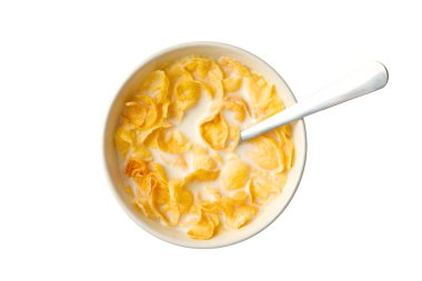 Süte batırılmış mısır gevreği, beyaz bir kaşıkla birlikte.