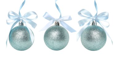 Three sparkling blue ornaments are hanging, isolated, PNG