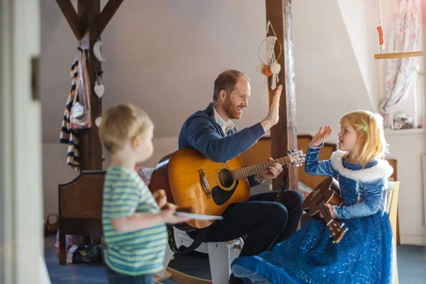 パパは子供たちにギターの弾き方を教えて — ストック写真