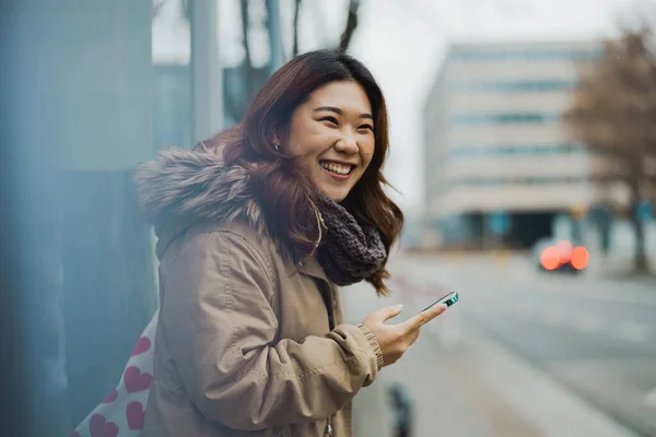 Young Woman Using Mobile Phone While Standing Bus Stop — Stock Photo, Image