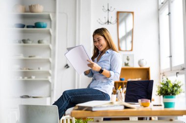 Young female freelancer working in loft office