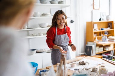 Young woman working in a pottery studio