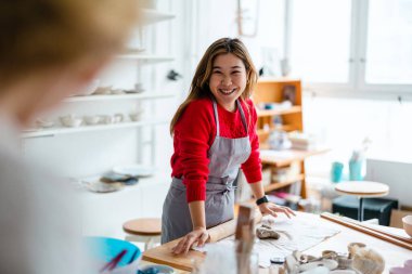 Young woman working in a pottery studio