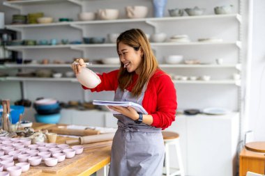 Young woman working in a pottery studio