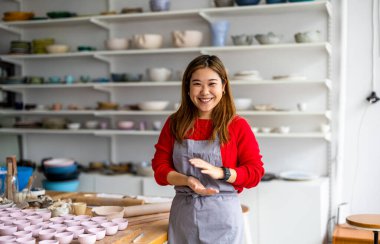 Young woman working in a pottery studio