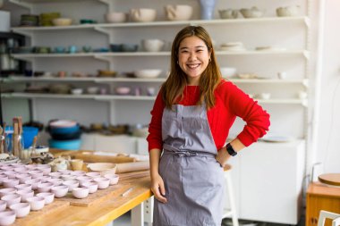 Young woman working in a pottery studio