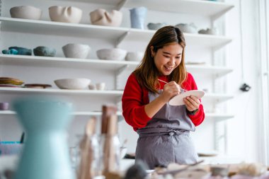 Young woman working in a pottery studio