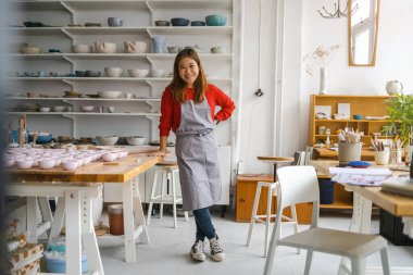 Young woman working in a pottery studio