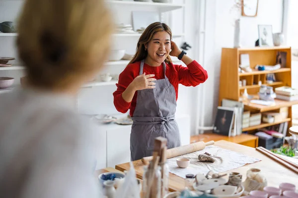 Young woman working in a pottery studio