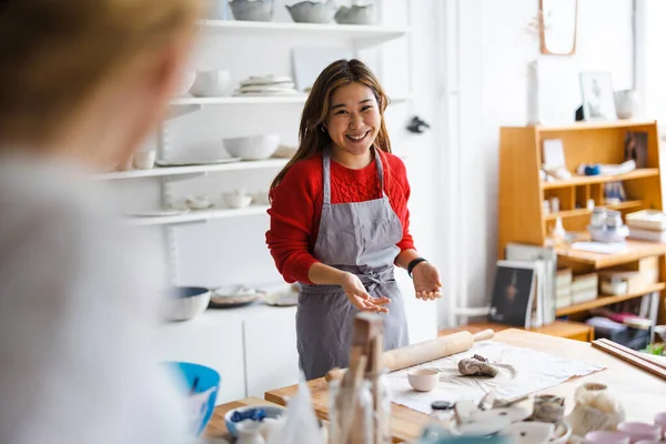 Young woman working in a pottery studio