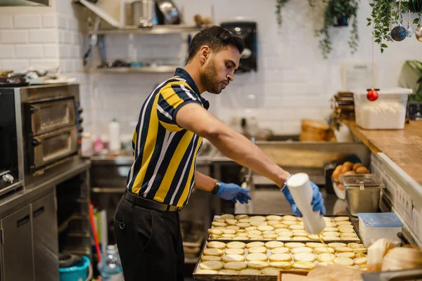 stock image Young man preparing fresh food in commercial kitchen