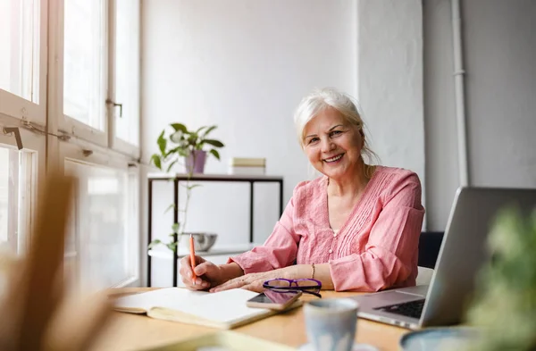Smiling Mature Businesswoman Writing Notebook While Sitting Table Office — Stock Photo, Image