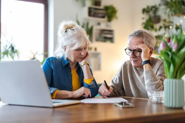 Senior Couple Sitting Table Discussing Home Finances Stock Image