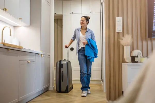stock image Young woman entering rented apartment with luggage
