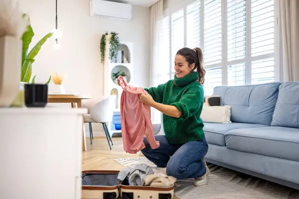 Young Woman Unpacking Her Clothes Rented Apartment Stock Picture
