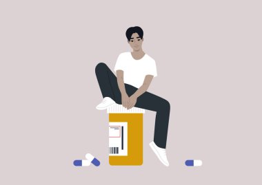 Genç bir Asyalı erkek, reçeteli ilaç şişesinin üzerinde oturuyor. Tıbbi tedavi görüyor.