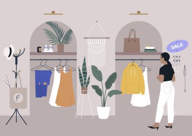 Moda mağazası, organik malzemeler, aksesuarlar, el yapımı dekor, etrafta dolaşan bir müşteri.