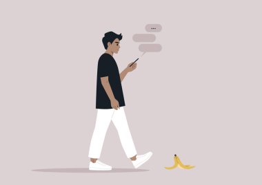 Akıllı telefonlarına bağımlı genç bir beyaz erkek. Yolda bir muz kabuğunu görmezden geliyor.