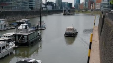 Almanya, DÜZSELDORF, 2022 dolayları. Ren Nehri 'ndeki Media Harbor' da tekneleri ve yatları olan bir marina. Limandan iki yat kalkıyor..