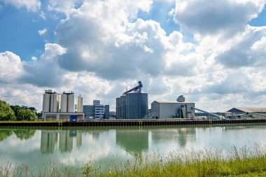 Agro-processing facility for processing, drying, cleaning and storing agricultural products, flour, cereals and grain. Barn elevator on the bank of the canal.