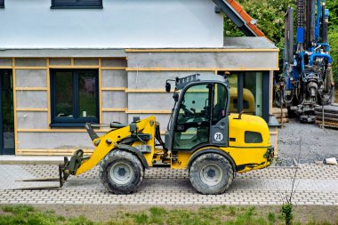 Yellow wheeled tractor forklift. Construction equipment for lifting and moving loads. Forklift