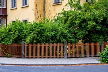 Yol kenarında kahverengi ahşap bir çit Almanya 'da bir evin yanında..