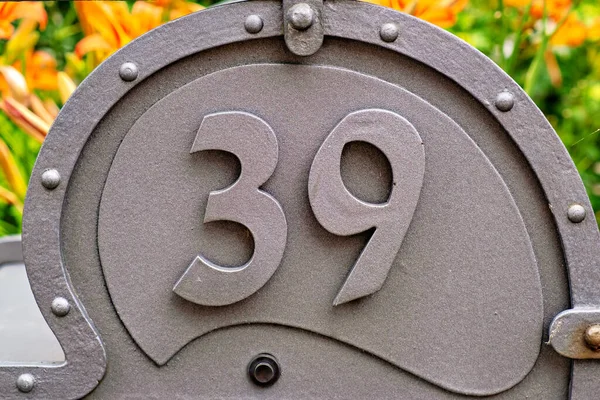 Close-up of a metal sign with house number 39 in Germany.
