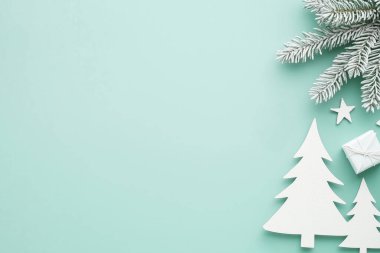 Minimalist White Christmas Trees and Pine Branch on Mint Green Background for Holiday Decor clipart