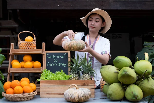 Native Asia woman selling natural variety of fruits at the farm stay, Homestay at Thailand Loei