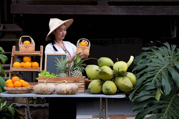 Native Asia woman selling natural variety of fruits at the farm stay, Homestay at Thailand Loei