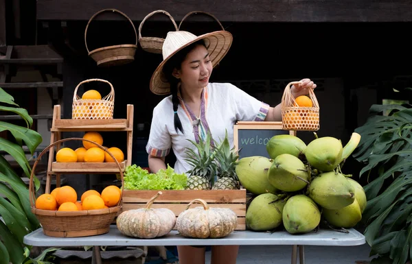 Native Asia woman selling natural variety of fruits at the farm stay, Homestay at Thailand Loei