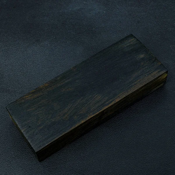 Sawn timber of rare Ebony wood with a beautiful pattern for crafts on black background