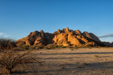 The Spitzkoppe in the desert. A group of bald granite peaks between Usakos and Swakopmund in the Namib desert of Namibia in the late afternoon. It is  The Spitzkoppe.