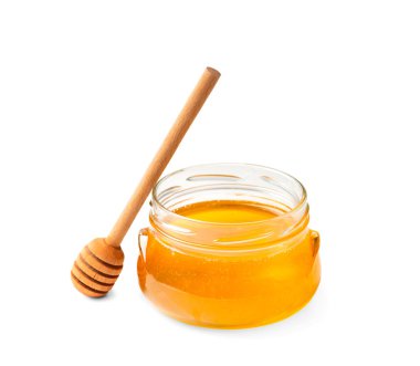 Fresh honey in a jar with a wooden dipper on a white isolated background.Honey in an open glass jar with a honey stick. Honey in a jar on a white background.