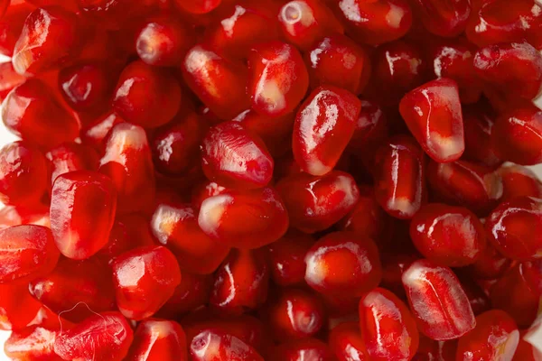 Ripe large pomegranate seeds for the background. Background from beautiful fresh pomegranate seeds.