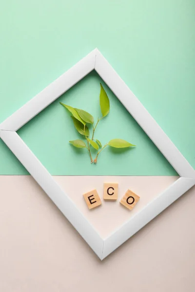 White frame and sprout on a fresh green background.. Mock up photo frame. Save the planet consept, eco friendly lifestyle.
