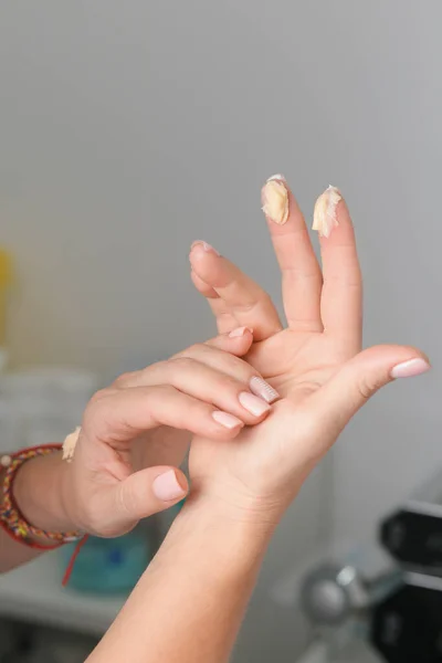 Cream on female hands. Applying cream to the hands. Hand skin care. Fashion and beauty.