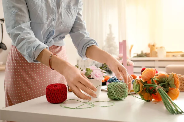 Girl makes flowers from the soap. Hobby, creative process. DIY gifts. Women's hands and flowers. Handmade soap. Mother's Day, Women's Day. Natural organic products. Flowers on a white table.
