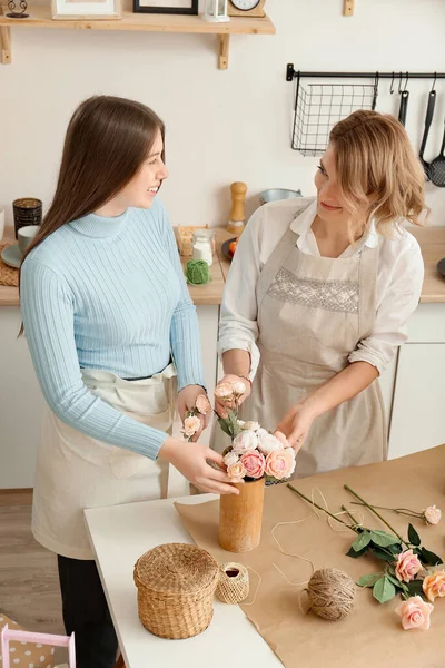 stock image Girls in the kitchen making flowers from soap. Hobby, creative process. DIY gifts. Women's hands and flowers. Handmade soap. Mother's Day, Women's Day, Birthday An interesting gift. Natural organic products. Flowers on a white table.