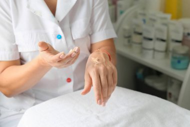 Cream on female hands. Applying cream to the hands. Hand skin care. Fashion and beauty.